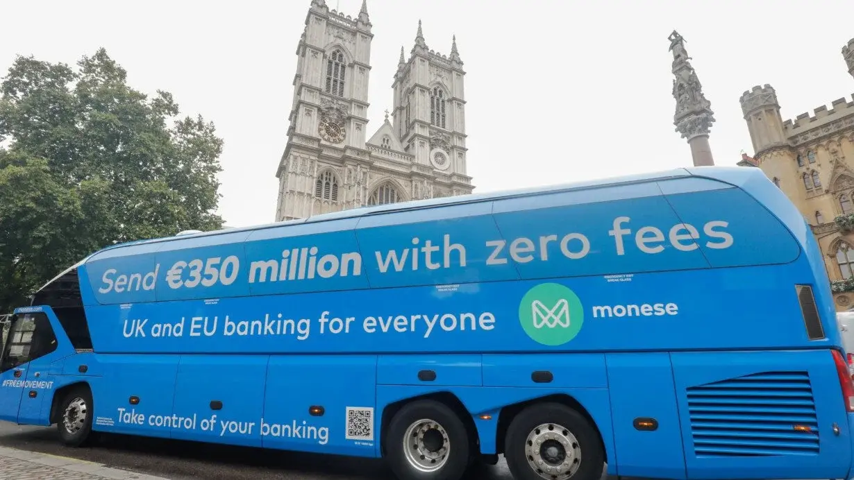Blue Monese campaign bus carrying the message Send 350 million euros with zero fees